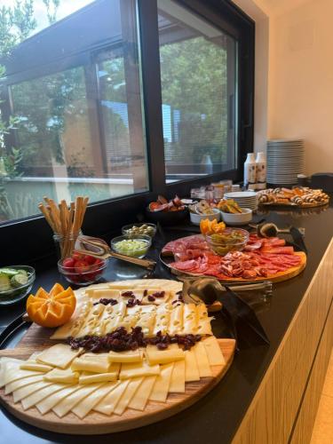 a buffet with many plates of food on a counter at Arena Prestige Rooms in Pula
