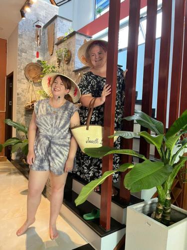 two women are posing for a picture on a staircase at Leila House - DaNang Central - 3BRs - Free Airport Shuttle in Da Nang