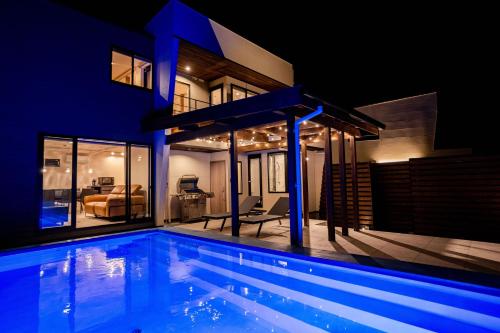 a swimming pool in front of a house at night at Montevan RESORT VILLA in Tateyama