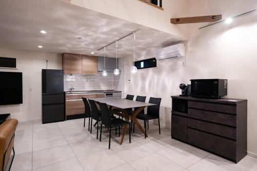 a kitchen and dining room with a table and chairs at Montevan RESORT VILLA in Tateyama