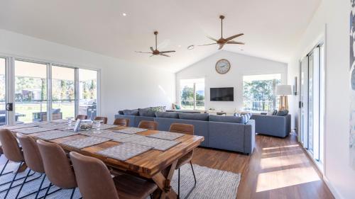 a living room with a table and a couch at Coopers Lodge, Lovedale - A rural escape in the heart of wine country in Lovedale