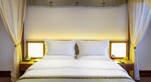 Cama o camas de una habitación en Langfang Ovation Hotel