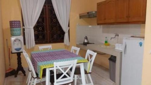 a kitchen with a table and chairs and a refrigerator at CICO Resort in Bogor