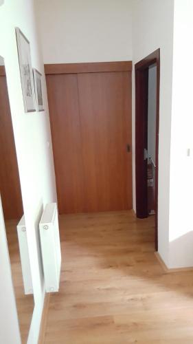 an empty room with a wooden floor and a door at Beautiful View Of Sarajevo Center in Sarajevo