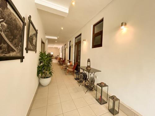a hallway with tables and chairs in a building at Maria Villa in Negombo