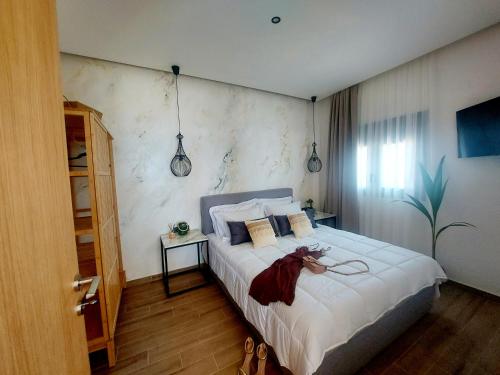 a bedroom with a bed with a dress on it at Euphoria Seafront Residence in Anissaras