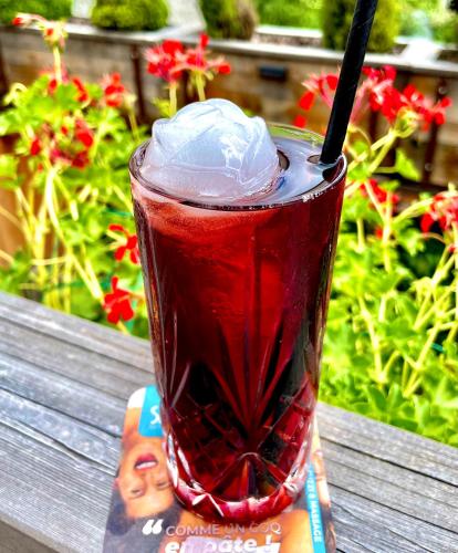 a drink in a glass sitting on a table at Chamois Lodge in Les Deux Alpes