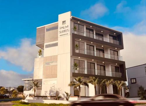 a building with a palm shades sign on it at 8 Ocean Rd in Auckland