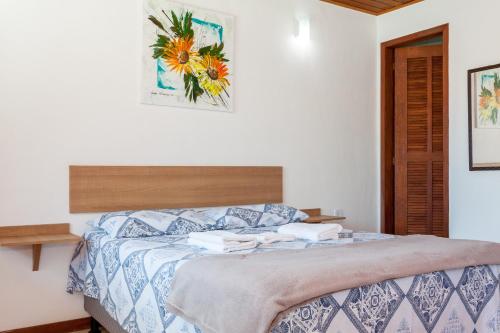a bedroom with a bed in a white room at Recanto do Jack in Búzios