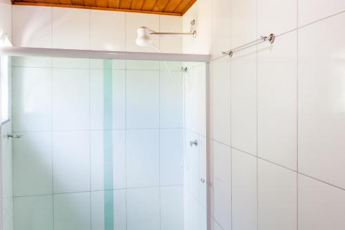 a shower with a glass door in a bathroom at Recanto do Jack in Búzios