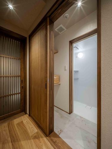 a hallway with a sliding door and a glass door at Suiki Machiya House in Kanazawa