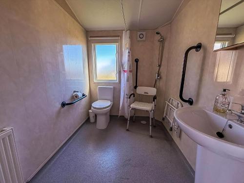 a bathroom with a toilet and a sink and a tub at Great 4 Berth Caravan With Wheelchair Access In Suffolk, Ref 68129Bs in Lowestoft