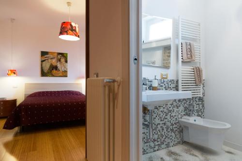 a bathroom with a sink and a bed at Guest House Le Acacie in Spoltore