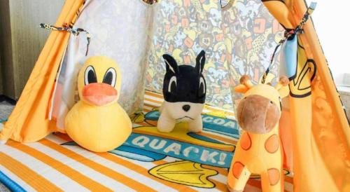 a group of stuffed animals sitting on a crib at Golden Eagle Summit Hotel Kunshan in Suzhou