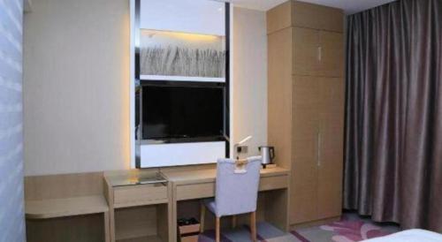 a room with a desk with a window and a computer at Lavande Hotels Suzhou Railway Station in Suzhou