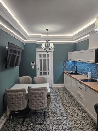 a kitchen with a table and chairs in a room at Apartament Twin II in Żywiec