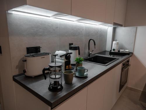 a kitchen with a sink and a counter top at Canva Living in Xanthi