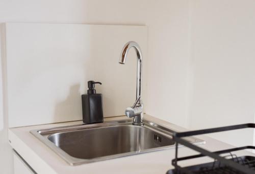 a stainless steel kitchen sink with a faucet at Casolare Cento Ulivi Luxury & Charme in Ascea