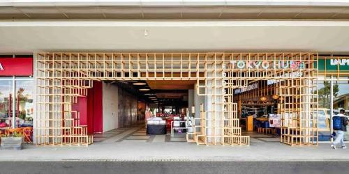 a store front with a wooden structure in front of it at Tokyo Riverside PIK 2 by Kakarama Room in Muara