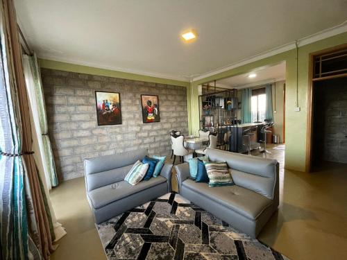 a living room with two couches and a table at Kigo Close Apartments in Kigo
