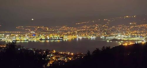 a view of a city at night with a harbor at ANKARAN SOBE MARA in Ankaran