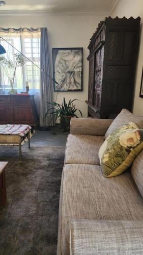 a living room with a bed and a chair at The smallest farm in Africa ELGIN in Grabouw