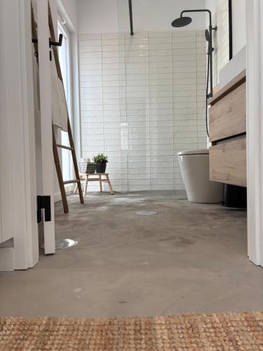 a bathroom with a tub and a sink and a bath tub at Casas do Mercado, 3 in Montemor-o-Novo