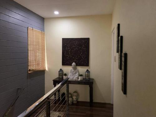 a statue sitting on a table in a hallway at Affordable fully furnished house in Bataan with pool in Orani
