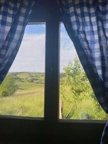 a window with a view of a field of grass at Farma 2 in Cazin