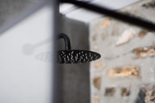 a black comb hanging from a wall at Casolare Cento Ulivi Luxury & Charme - Villa exclusive use in Ascea