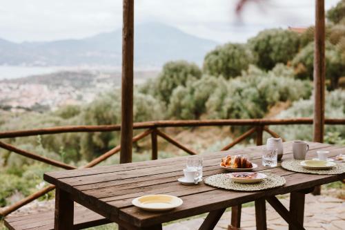 a wooden table with plates of food on it at Casolare Cento Ulivi Luxury & Charme - Villa exclusive use in Ascea