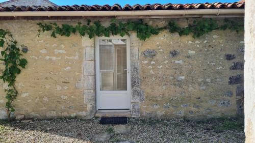 une porte blanche sur le côté d'un bâtiment en briques dans l'établissement Dependance, à Touvre
