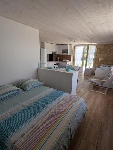 Cet appartement comprend une chambre avec un lit et une cuisine. dans l'établissement Maison de campagne 4 couchages avec piscine et lacs, à Sainte-Radegonde