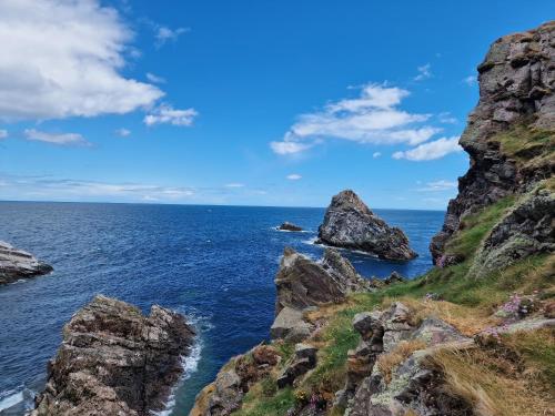 a view of the ocean with rocks in the foreground at Failte Stay in Inverness