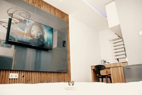 a television on a wall in a room at Cozy Akoka Studio Near Unilag in Lagos