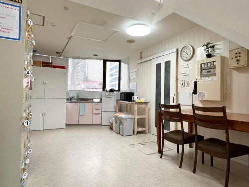 a kitchen and dining room with a table and chairs at stay papiyon 博多 in Fukuoka