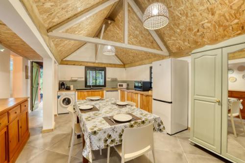 a kitchen with a table and chairs in a room at La Kaz Mamie in Petite Île