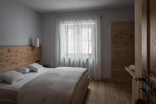 Ένα ή περισσότερα κρεβάτια σε δωμάτιο στο Chalet Laura Lodge Hotel