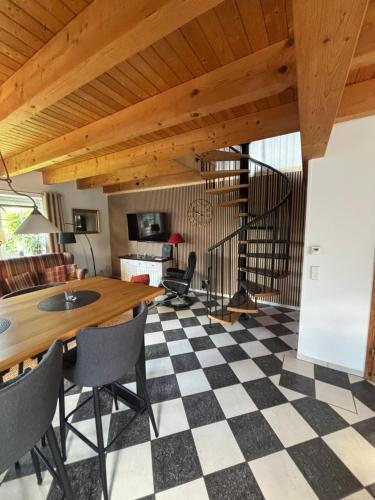 a living room with a table and a checkered floor at Gemütliches Landhaus in ruhiger Lage. in Moringen