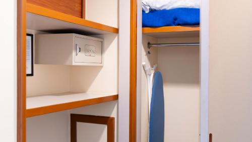 a small room with a closet with a bunk bed at Hotel Abastos Plaza in Mexico City