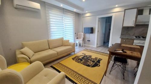 a living room with a couch and a table at Oznur House in Dalaman