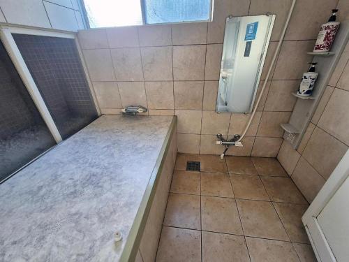 a small bathroom with a shower with a sink at Tokyo House INN in Tokyo