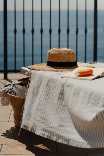 a hat sitting on top of a table with a tableablishthritisthritisthritisthritis at HOTEL DEL GOLFO in Finale Ligure