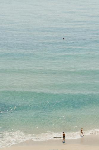 two people playing with a frisbee on the beach at HOTEL DEL GOLFO in Finale Ligure