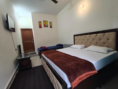 a bedroom with a large bed in a room at Sri Shakti Hotel and restaurant in Chandrāpuri