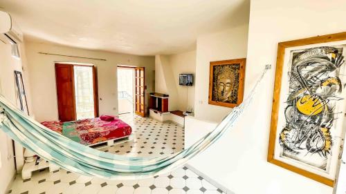 a room with a hammock in a house at Roof top Terrace house in Scalea