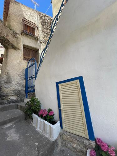 a door on the side of a building with flowers at Roof top Terrace house in Scalea