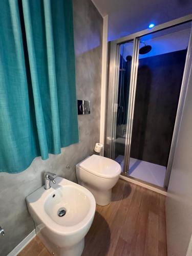 a bathroom with a toilet and a sink and a shower at Dune Prestige & Chalets in Bibione