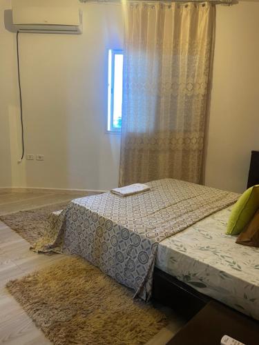 a bedroom with a bed and a window at cosy Furnished appartment in Ez Zahra
