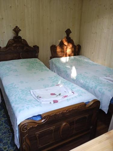 two beds sitting next to each other in a room at M & D hotel in Tsqaltubo